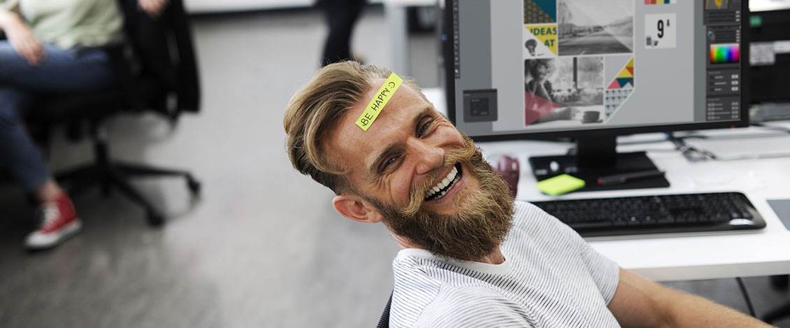 Photo of Bearded Man with a Be Happy Sticker on his Forehead