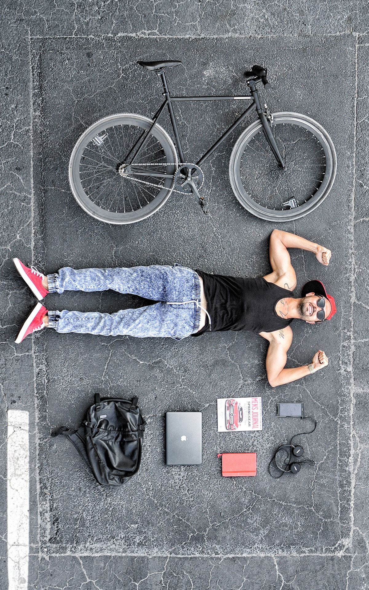  Man and Bike Lie on Concrete